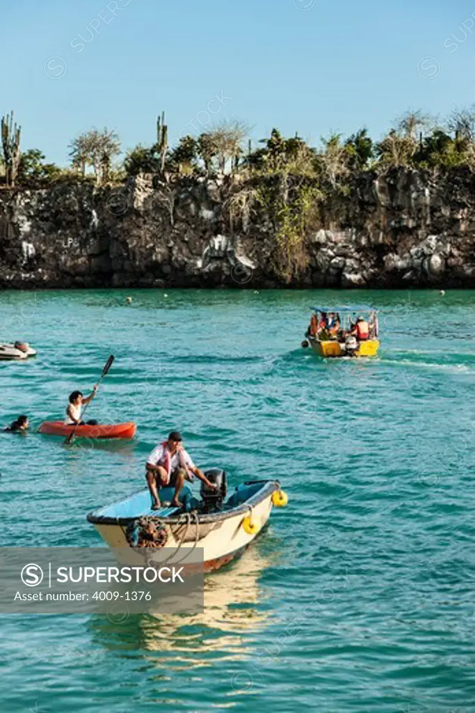 Ecuador, Galapagos Islands, People on boats in sea