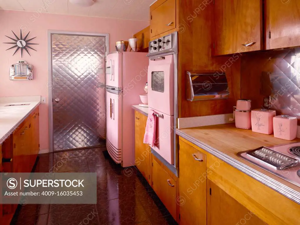 Mid century pink kitchen with pink appliances. - SuperStock