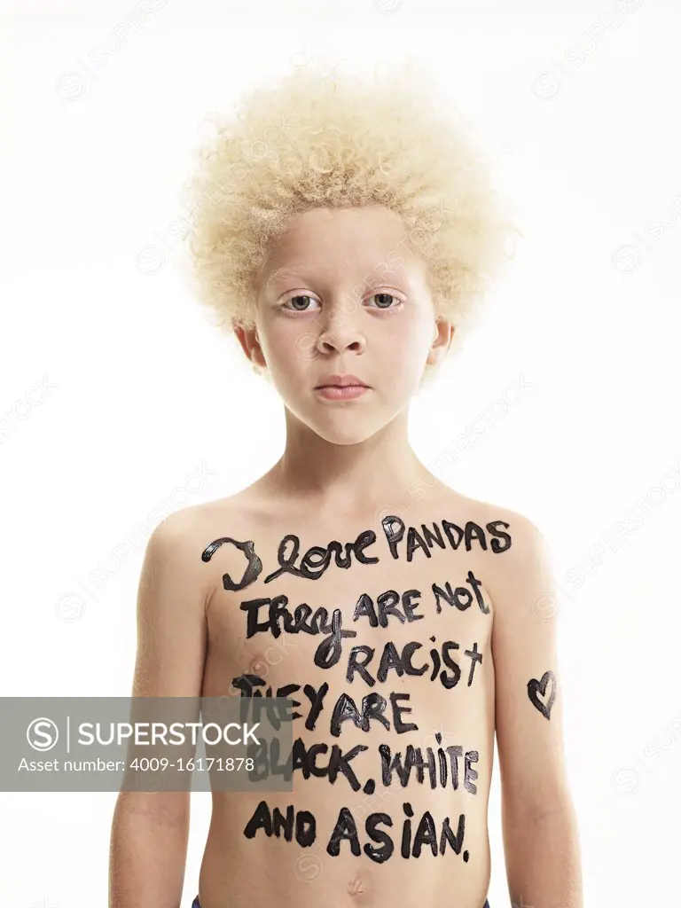 Portrait of Albino boy with words painted on body "I love pandas, They are not racist, they are black, white and Asian"