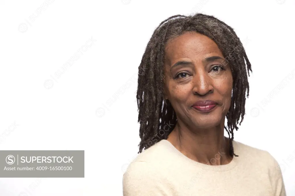 Portrait of older black woman looking at camera with subdued smile