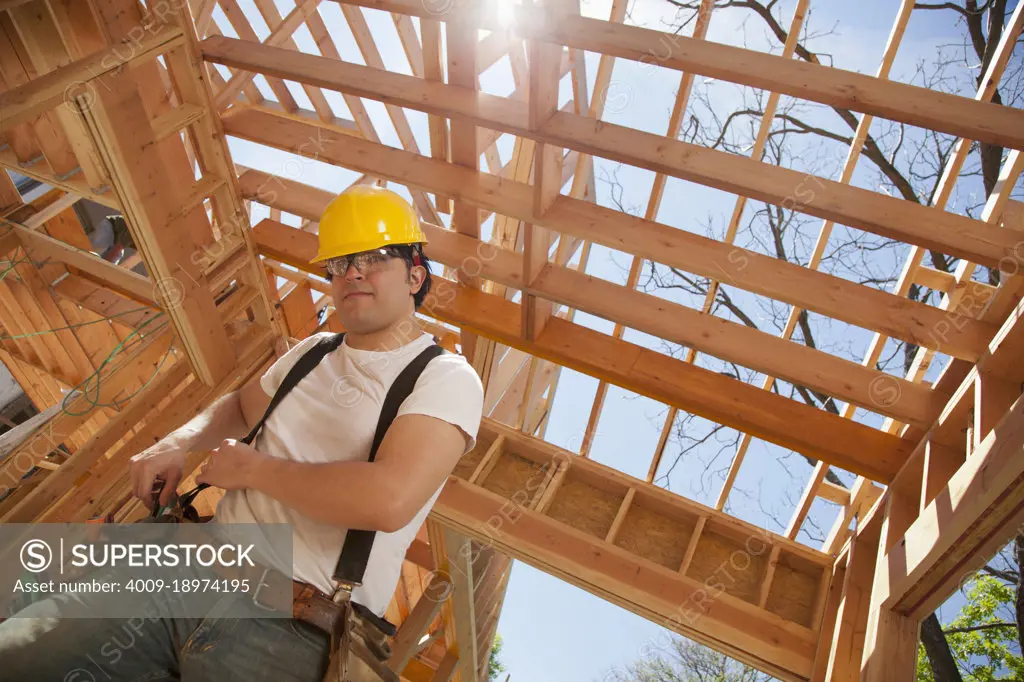 Low angle view of a man working at a residential construction site