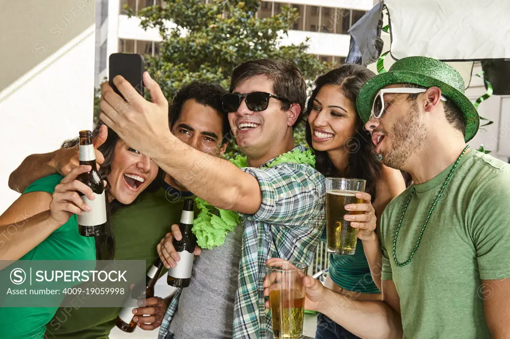 Friends with beer making selfie on St.Patrick's day