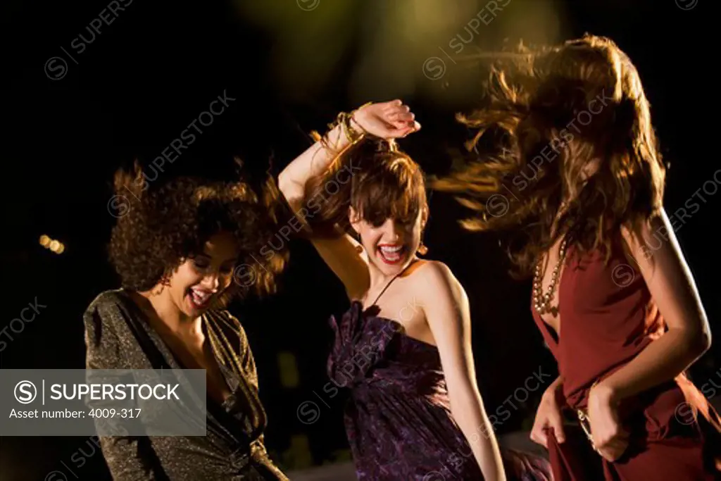 Women dancing in a party on rooftop, Manhattan, New York City, New York State, USA
