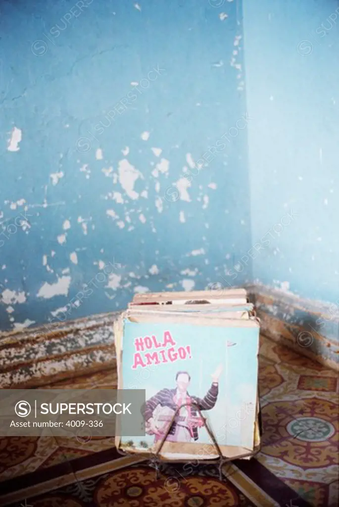 LP records in a corner of room with paint peeling walls, Cuba