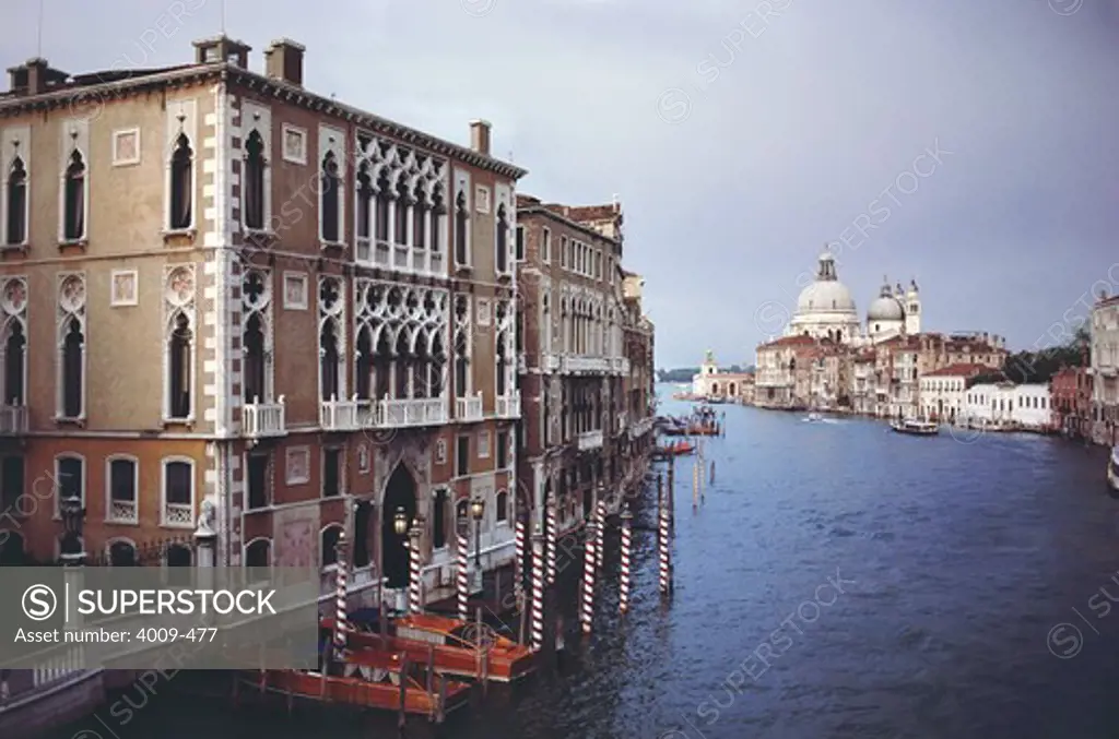 Boats moored at canal with Basilica in the background, Santa Maria Della Salute, Dorsoduro, Grand Canal, Venice, Italy