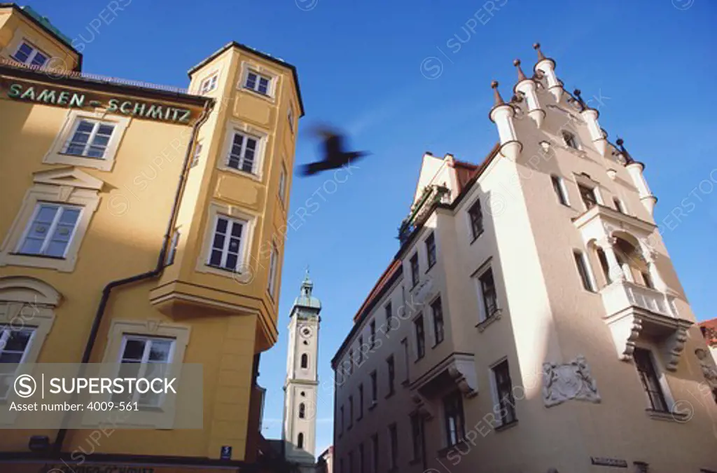 Low angle view of buildings with a church in the background, Heiliggeistkirche, Munich, Bavaria, Germany
