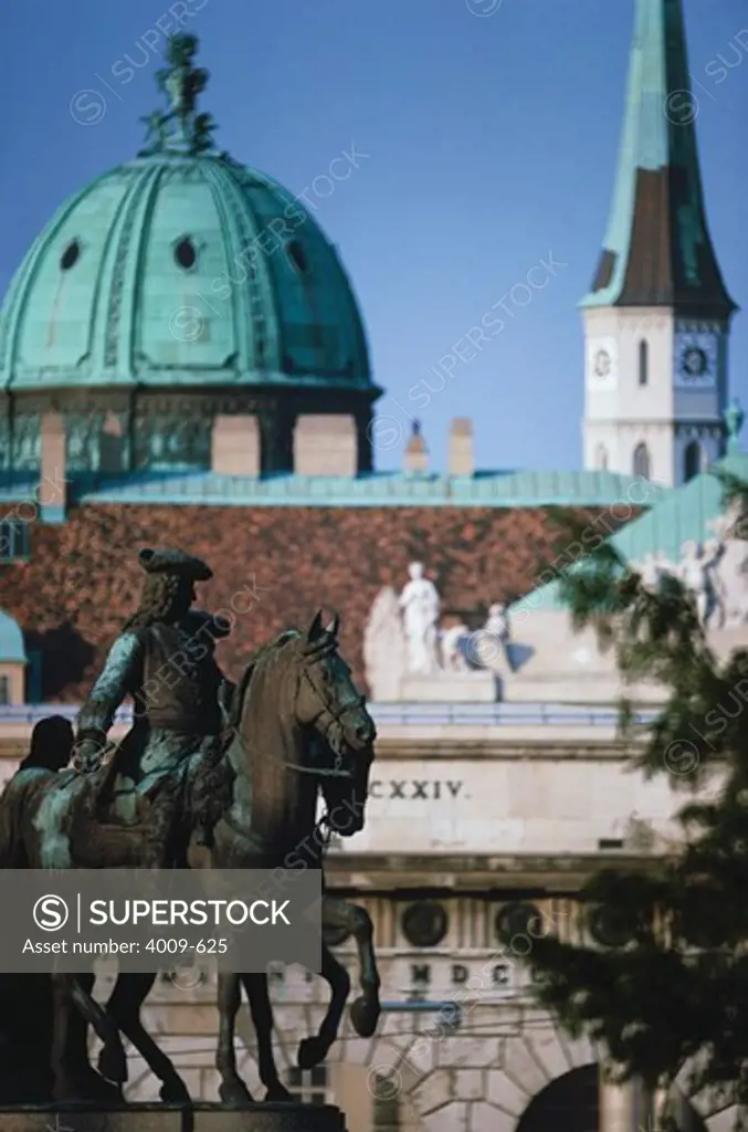 Equestrian statue with a dome of a palace in the background, The Hofburg Complex, Vienna, Austria