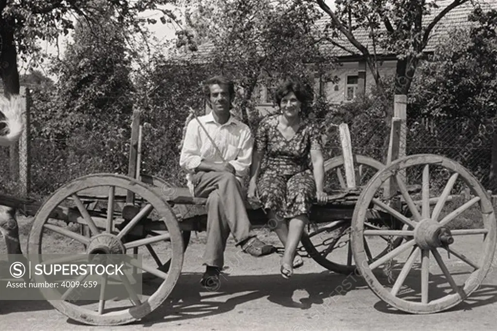 Couple sitting on a wagon, Gyor, Hungary