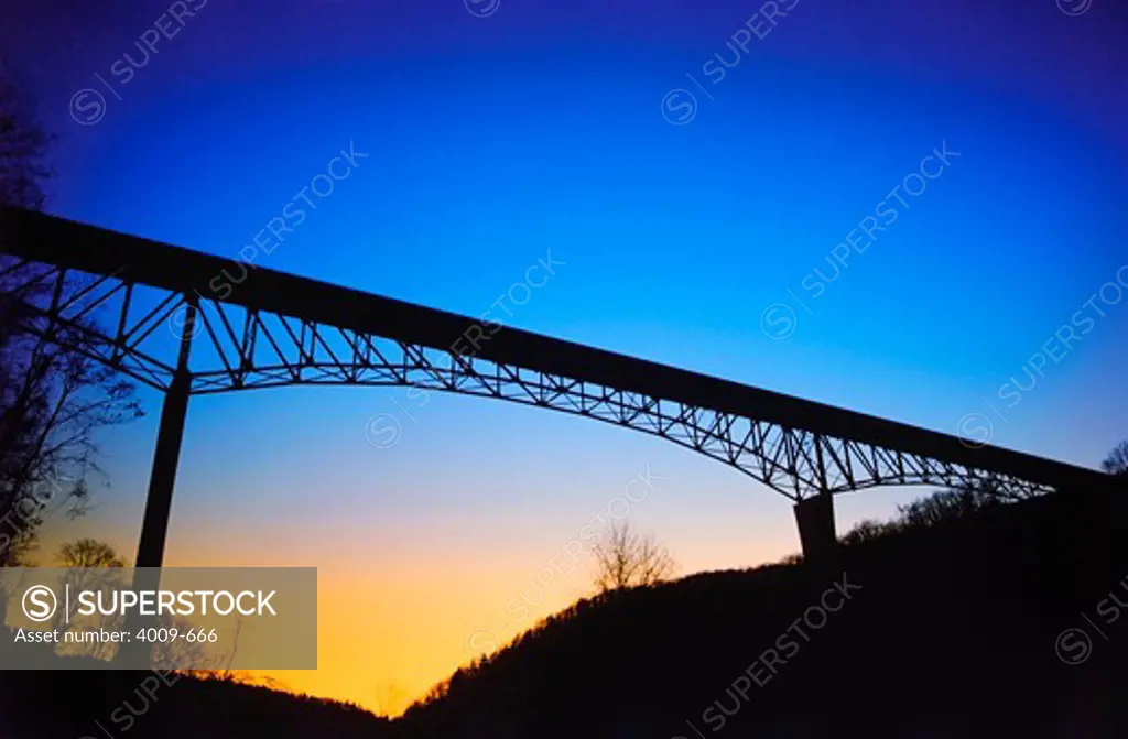 Silhouette of a steel arch bridge, West Virginia, USA