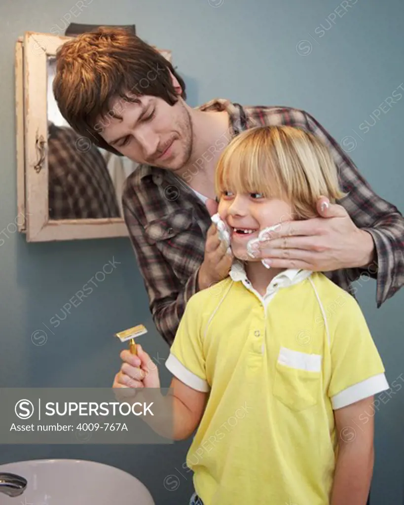 Man teaching to his son how to shave