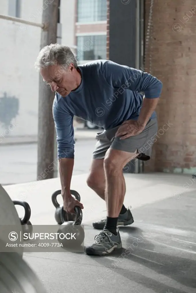 Man exercising with kettle bell