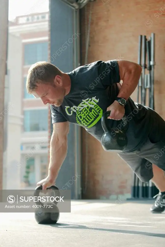 Man exercising with kettle bell
