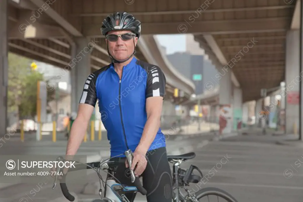 Portrait of a cyclist with his bicycle