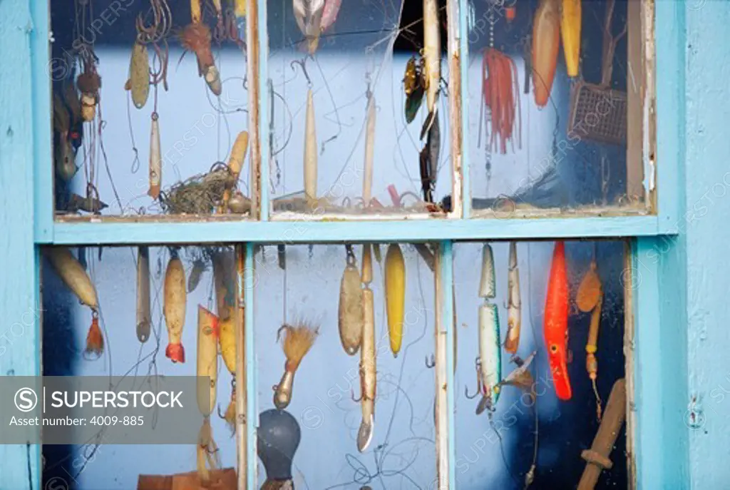 Fishing lures hanging inside a window at Menemsha Harbor, Martha's Vineyard, Dukes County, Massachusetts, USA