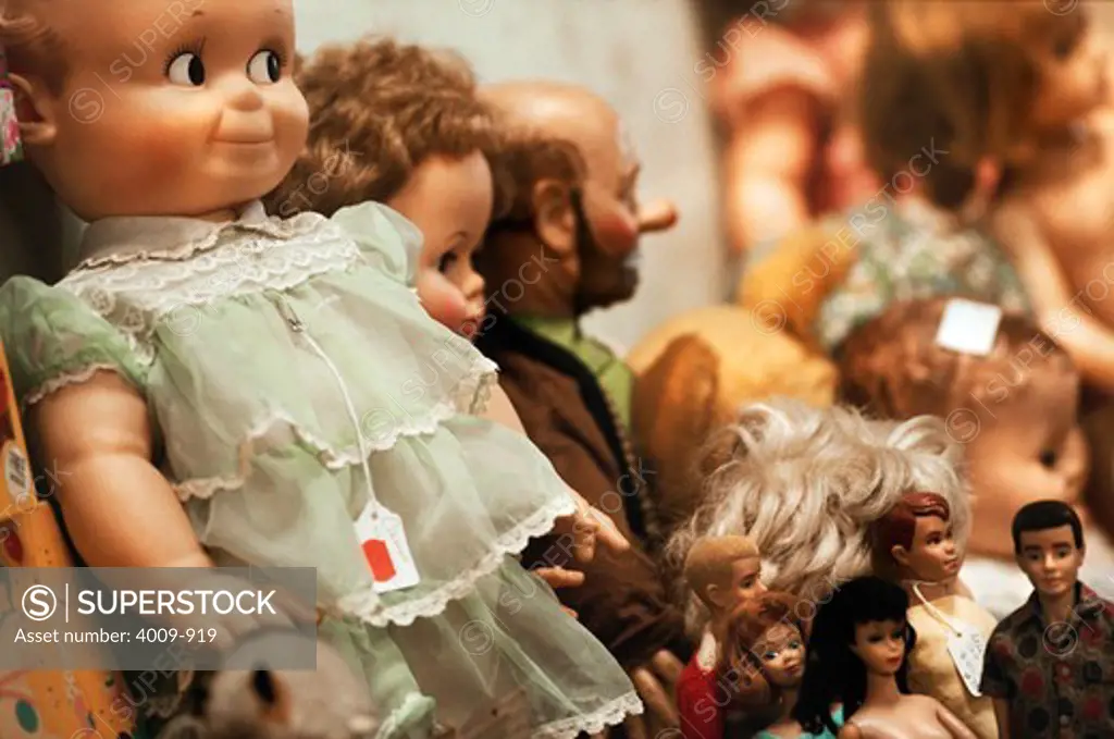 Collection of vintage dolls, Barbie dolls and a clown doll in a store window
