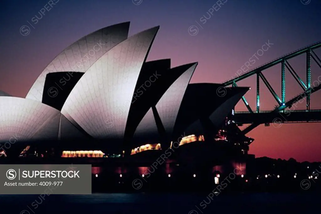 Silhouette of an opera house and bridge, Sydney Opera House, Sydney Harbor Bridge, Sydney, New South Wales, Australia