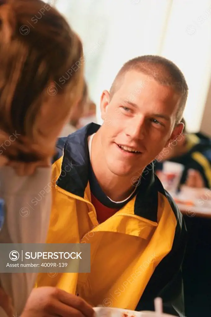 Young man talking with a woman in a classroom