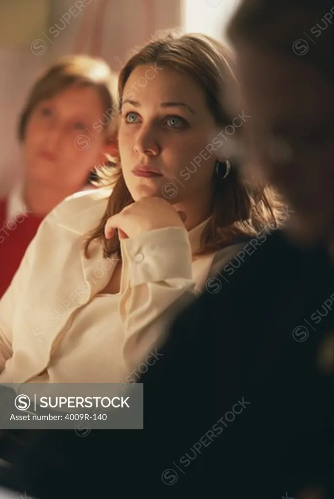Young woman listening to a lecture in a university classroom