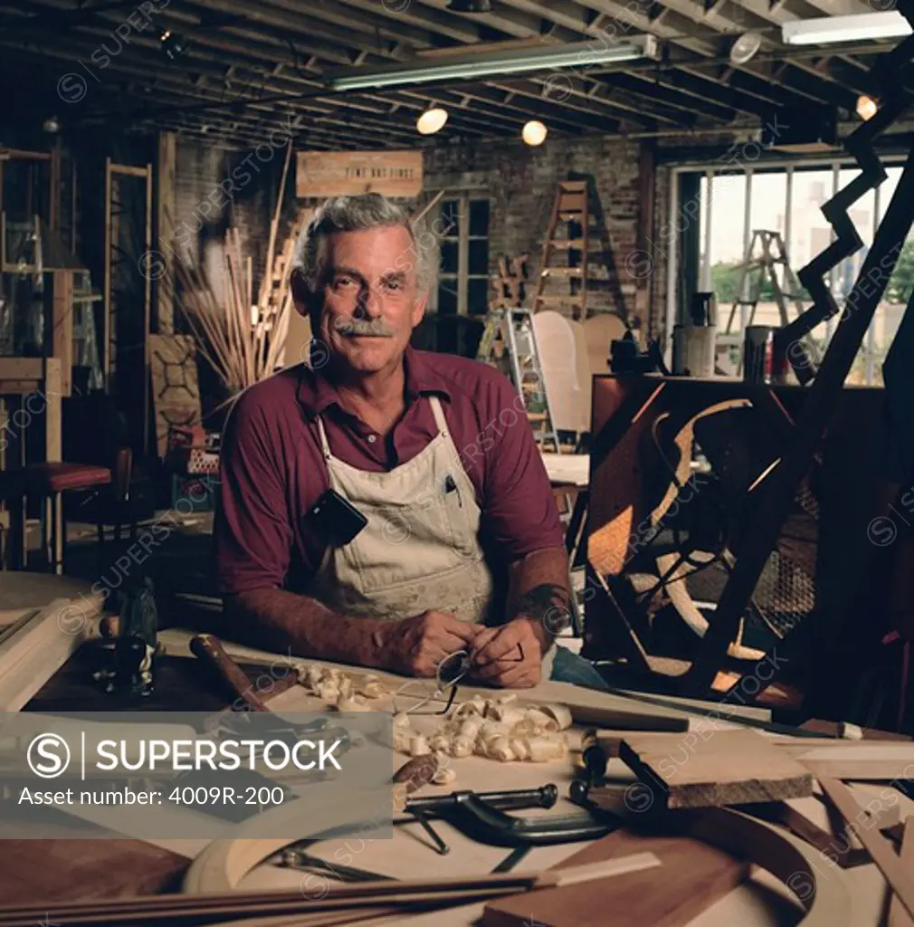 Portrait of male carpenter working in his wood shop