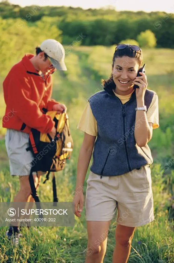 Mid adult woman talking on a mobile phone while hiking
