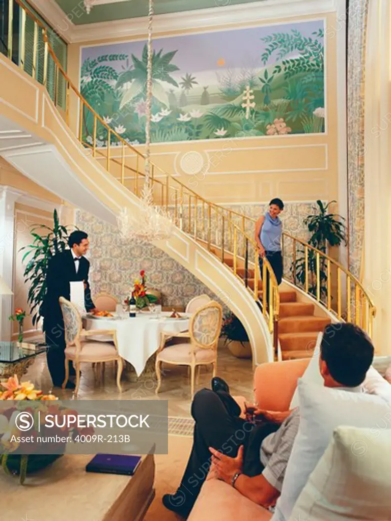 Woman moving down a staircase in a hotel