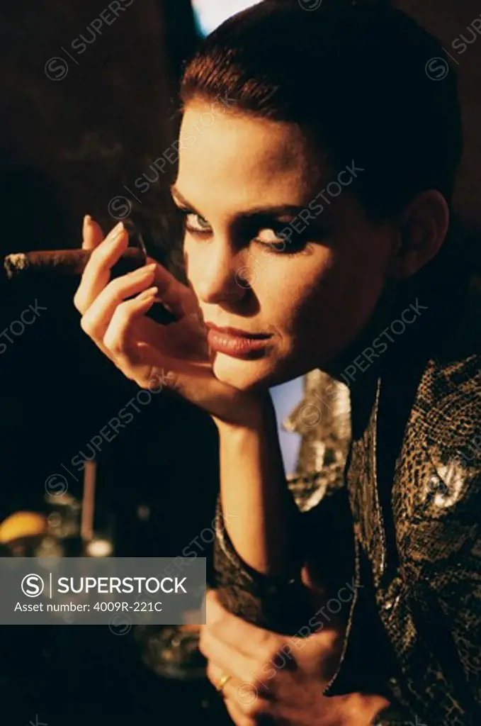 Young woman smoking a cigar in a bar