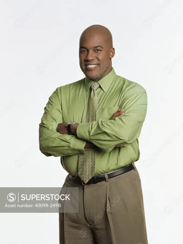 Businessman standing with his arms crossed and smiling