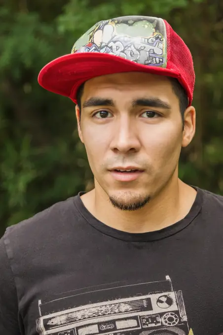 Serious Hispanic man in baseball cap