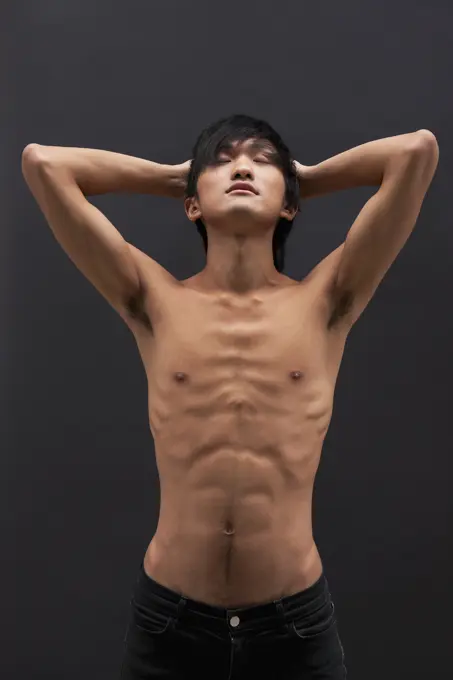 Shirtless Asian man posing