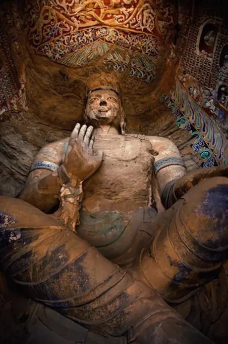 Low angle view of a Buddha statue in a cave, Yungang Buddhist Caves, Datong, China