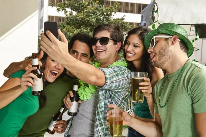 Friends with beer making selfie on St.Patrick's day