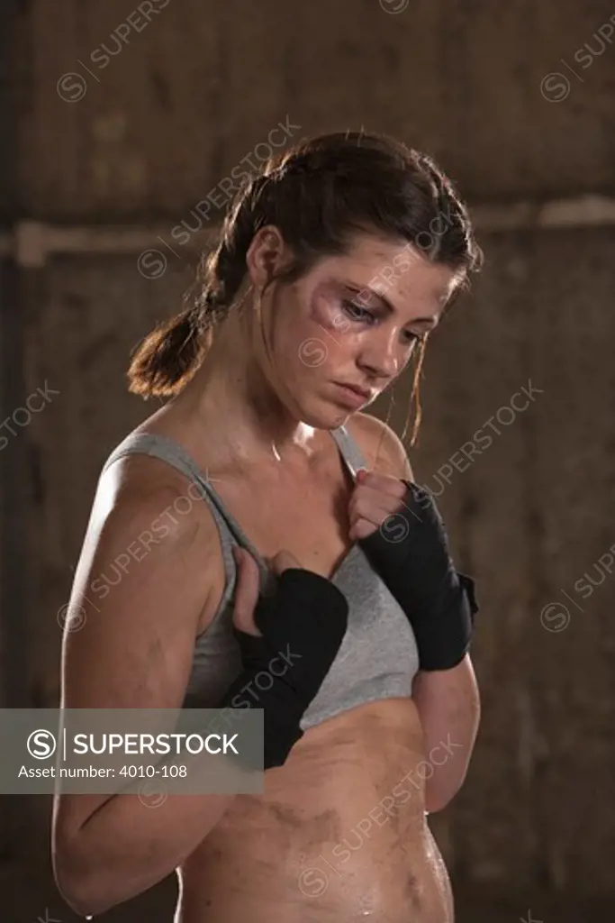 Female boxer looking tired during practice