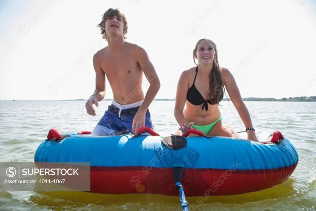 USA, Texas, Lewisville, Two teenagers about to ride on inner tube in Lake Lewisville