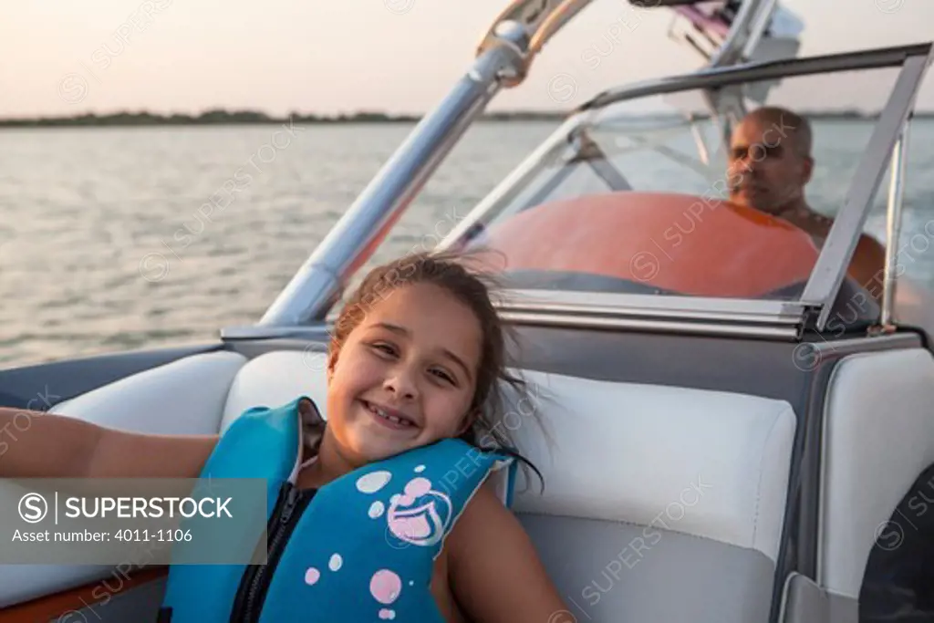 Father and daughter enjoying evening on boat