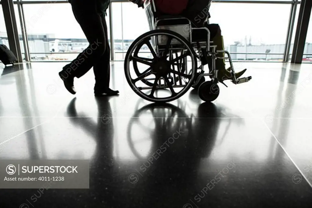 USA, illinois, Chicago, Business traveller in wheelchair at Chicago O'Hare international Airport