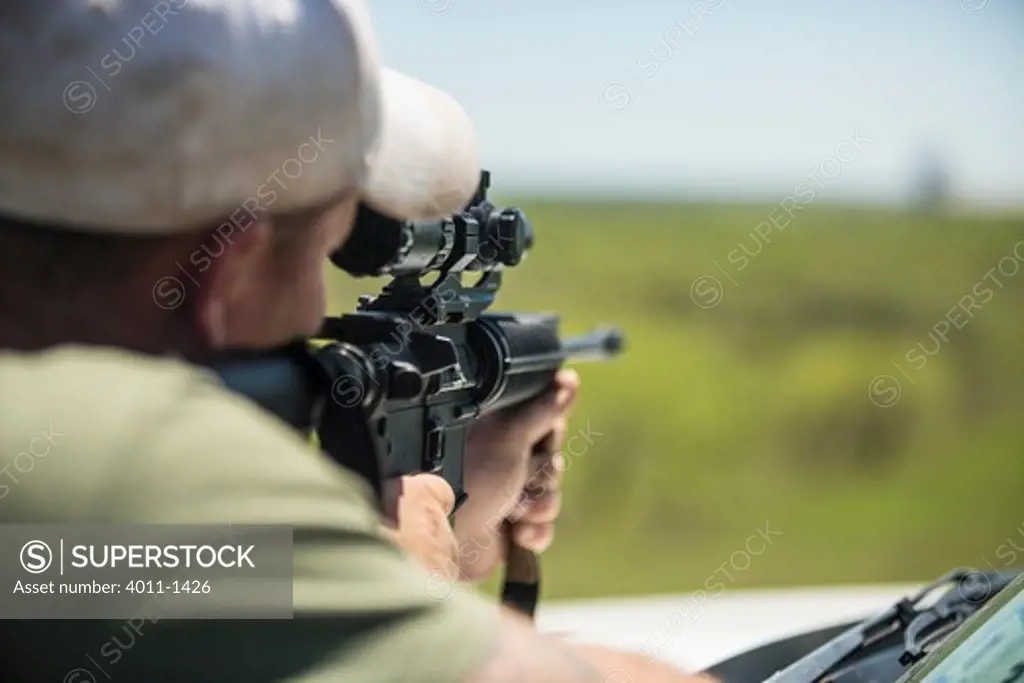 Hunter looking through scope of AR-15