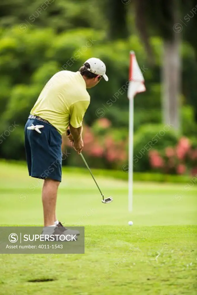 Costa Rica, Los Suenos, Golfer putting his golf ball from fringe
