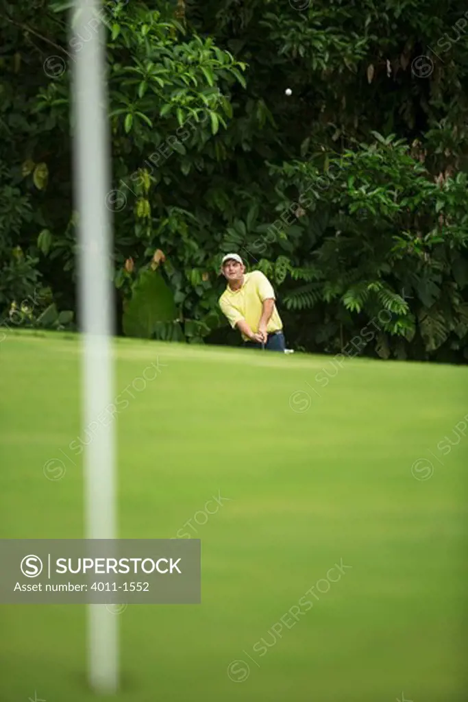 Costa Rica, Male golfer hitting ball