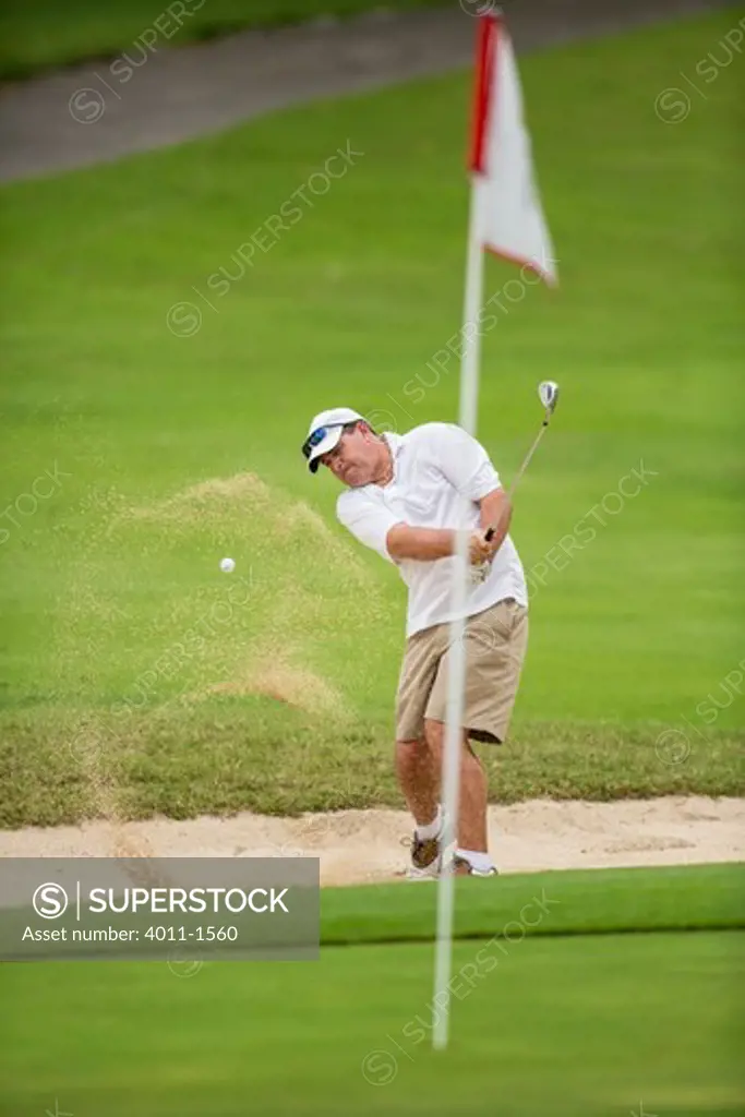 Costa Rica, Golfer hitting his ball out of  sand trap