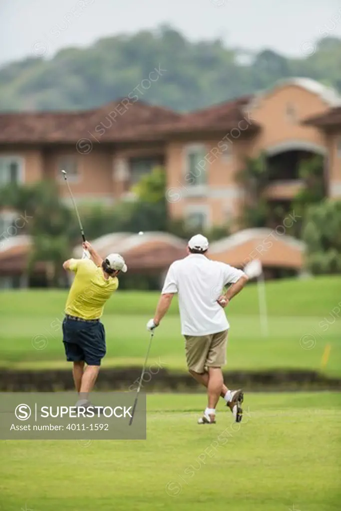 Costa Rica, Two Golfers teeing off over water