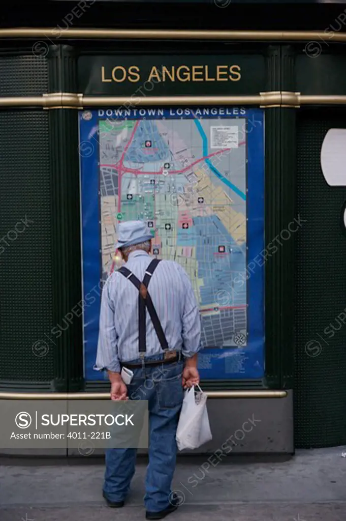 USA, California, Los Angeles, Old Man with suspenders looking at map of Downtown