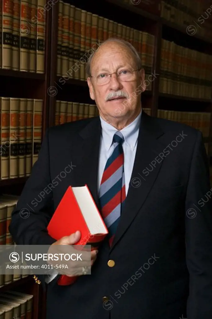 Lawyer holding a book in an office