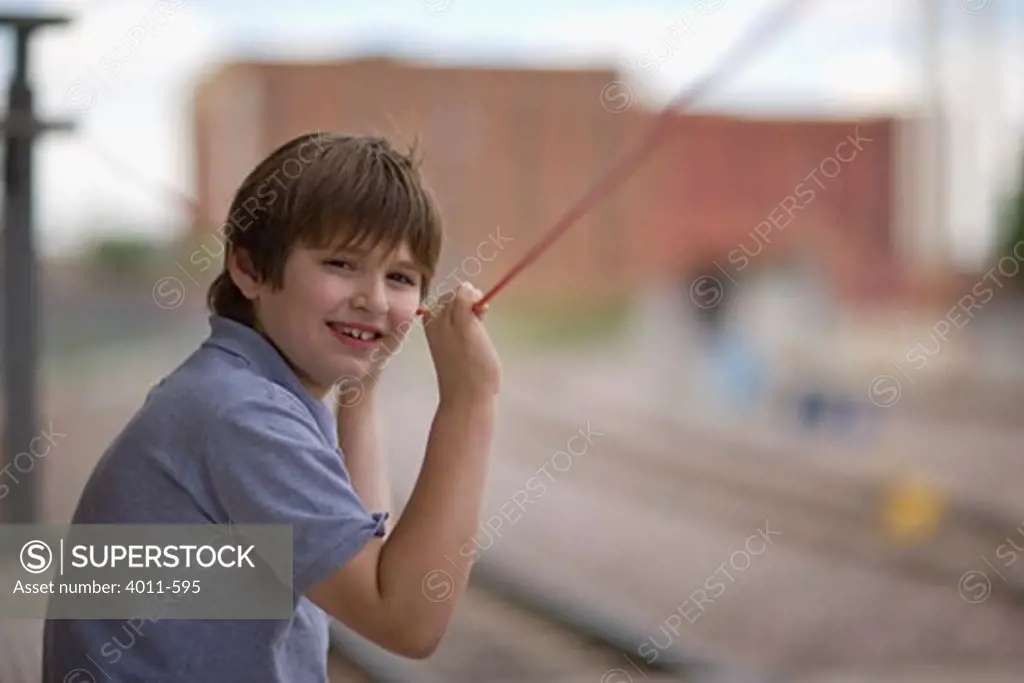 Boy waiting at a railroad station, Fort Worth, Texas, USA