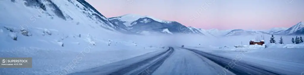 Snow covered road passing through mountains, Highway 135, Crested Butte, Gunnison County, Colorado, USA