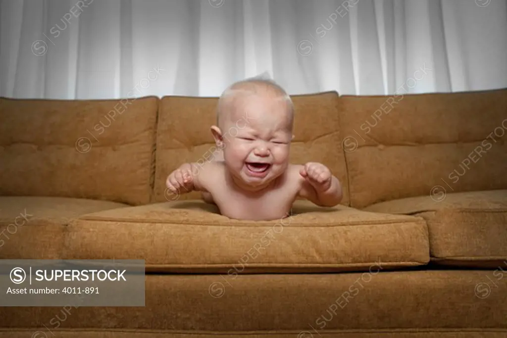 Seven month old baby on couch crying