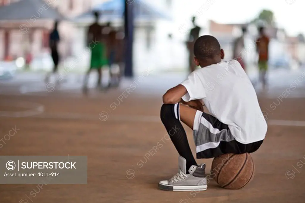 Young boy watching basketball game