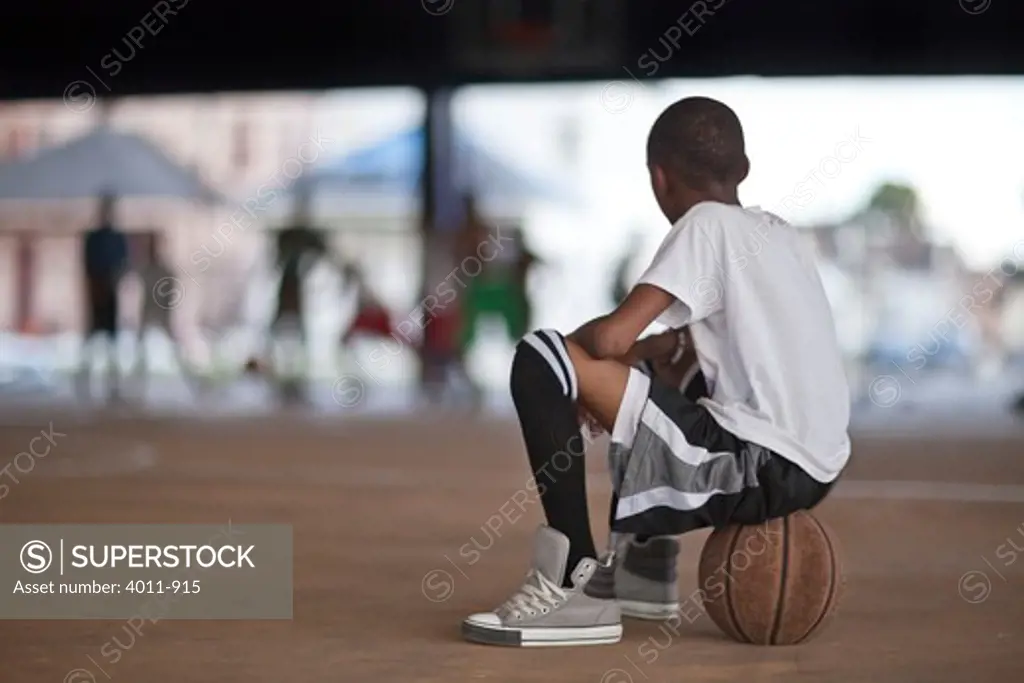 Young boy watching basketball game