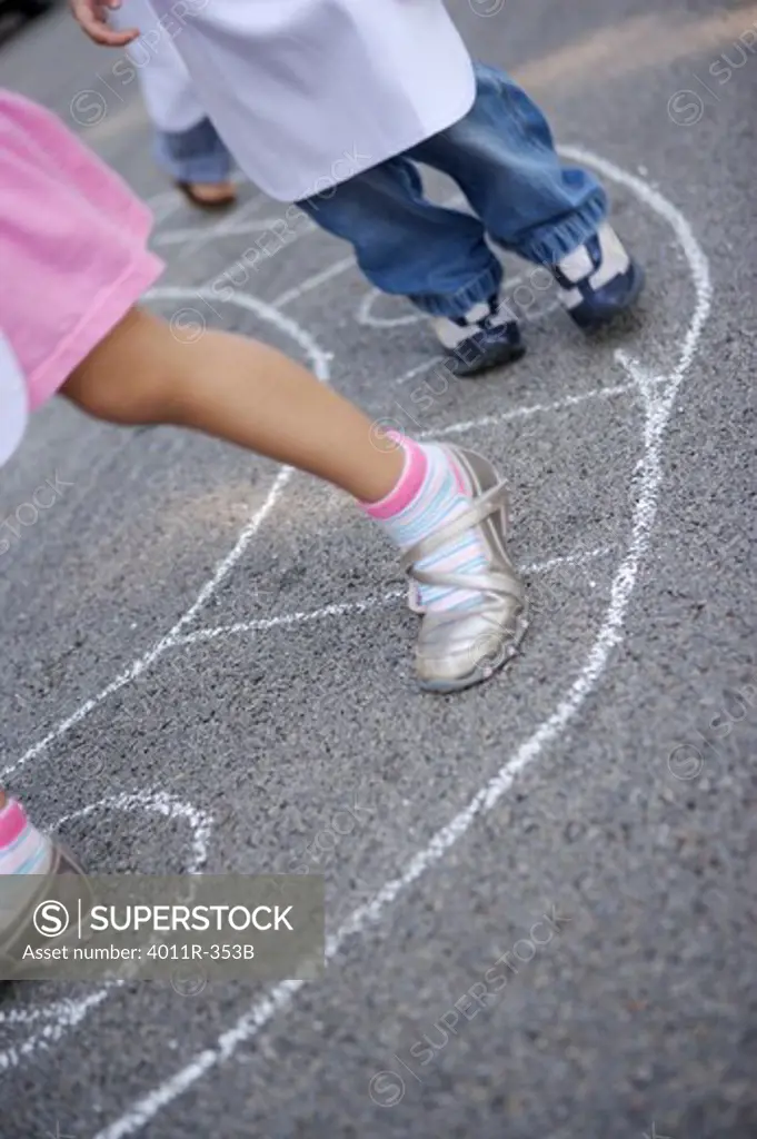 Kids  legs and feet walking and playing street game
