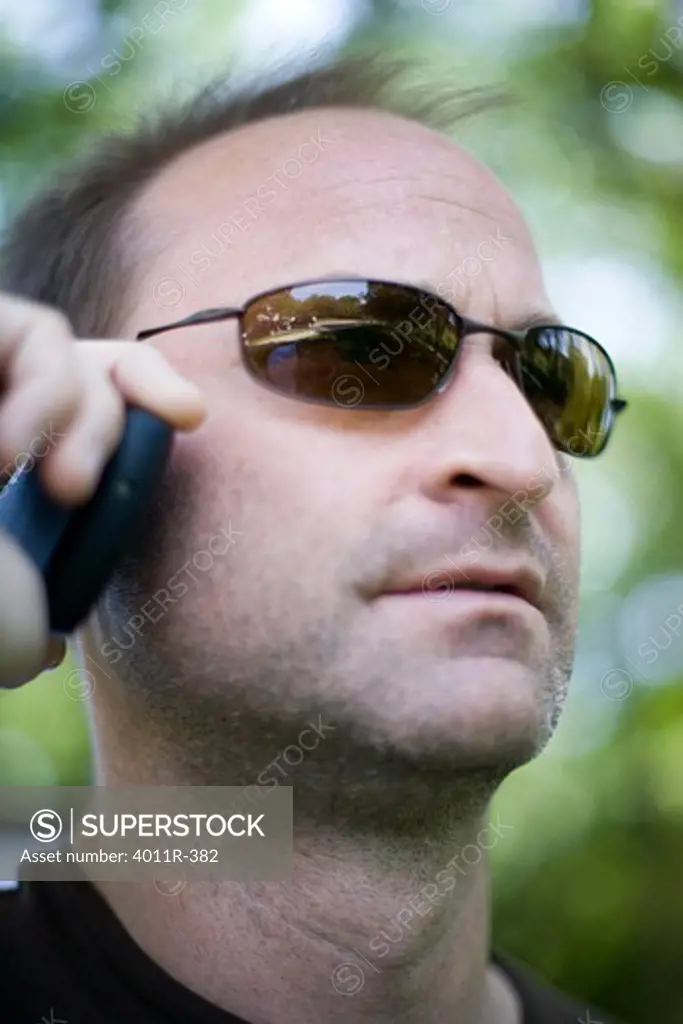 Close-up of a mid adult man talking on a mobile phone, Texas, USA