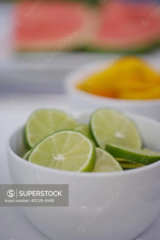 Close up of bowls with slices of fruits